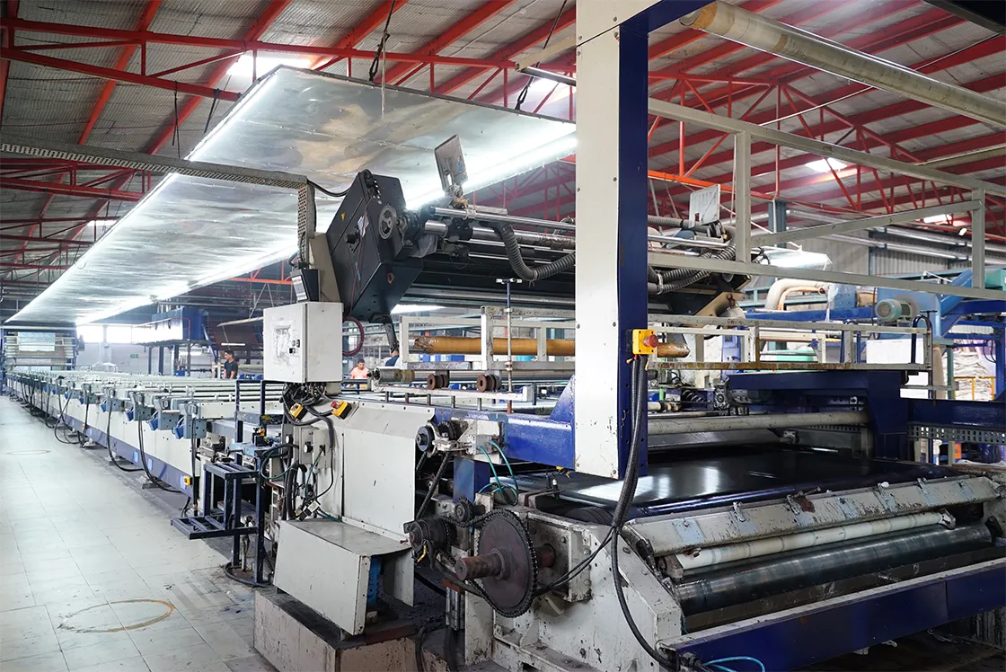 Flatbed screen printing machine in production on a textile factory floor